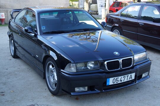 Black BMW E36 coupe sports car parked