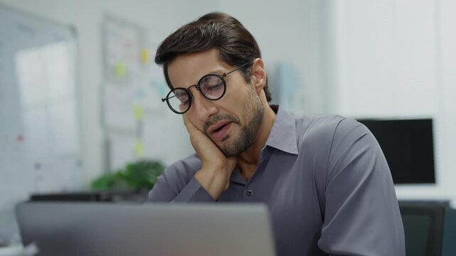 Latino businessman overworked and stressed during late-night shift. Latino professional working late, feeling tired and stressed at his desk, eating instant noodles amidst high-pressure deadline.
