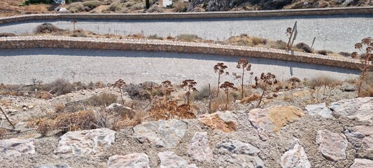 Winding path through rocky terrain in a dry landscape during midday sun