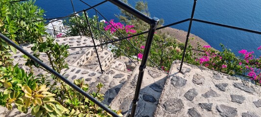 Stunning view from stone steps leading down to a vibrant coastal landscape adorned with colorful flowers