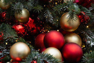 Christmas tree decorated red balls and lights garland. Xmas holiday spirit. Winter. Outdoors.