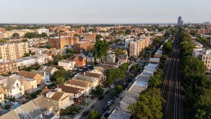 Top-down aerial view of a dense suburban neighborhood surrounded by forest 