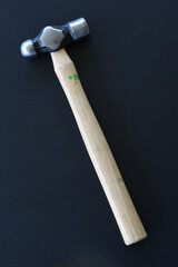 Ball-peen hammer on black background