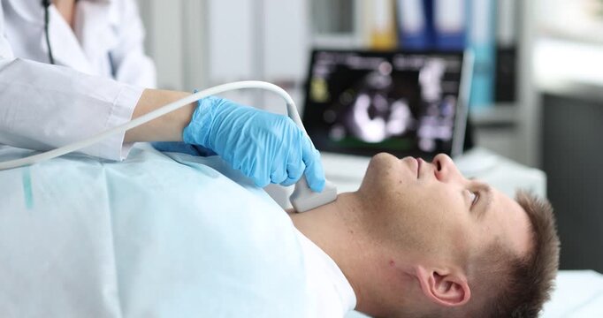 Man patient lies on examination couch while doctor scans neck. Specialist hand in blue glove presses ultrasound probe gently on thyroid area