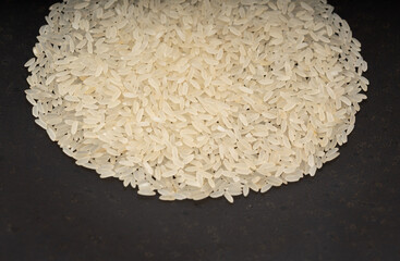 White parboiled rice grains. Dry uncooked ponni rice, small organic basmati