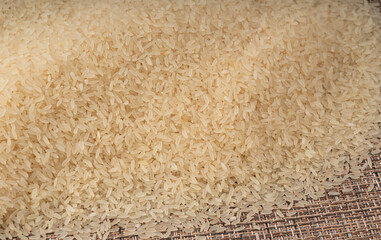White parboiled rice grains. Dry uncooked ponni rice, small organic basmati