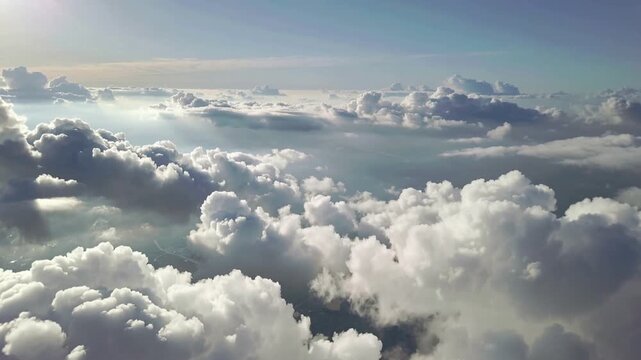 A serene aerial view soaring above fluffy clouds with soft light filtering through, creating a peaceful sky-high atmosphere.