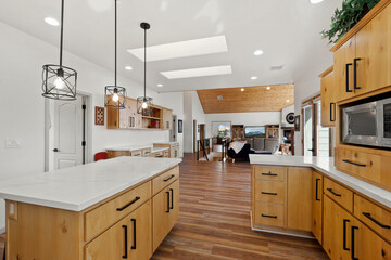 Fototapeta premium Openconcept Kitchen With Skylights, Wide Galley Style Kitchen With Natural Light And Sleek Counters
