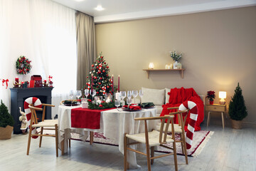 Festive table setting with Christmas decor indoors