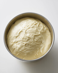 an overproofed dough overflowing from a stainless steel mixing bowl, the dough is swollen, glossy, irregularly shaped and bulging over the rim, showing signs of extreme fermentation, large air bubbles
