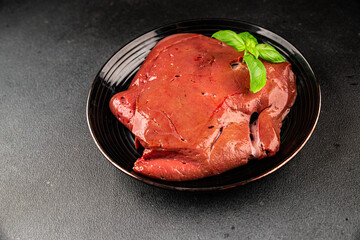 Liver raw veal or pork meat offal baked natural tasty appetizer fresh delicious gourmet food background on the table rustic top view copy space keto or paleo diet
