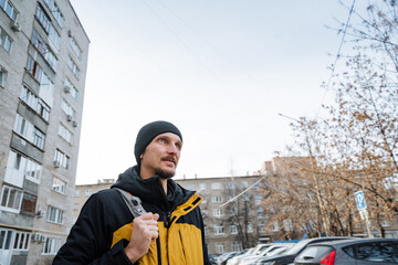 city walk scene, city resident wandering along lively urban sidewalks wearing vibrant outerwear, working individual in cheerful clothing enjoying brisk walk through bustling city streets