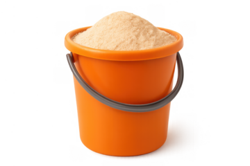 Orange plastic toy bucket pail filling with fine play sand from the beach, transparent background for children's activities
