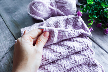 Woman hands knitting needles. knitting a scarf from a variety of wool yarn close-up view from...