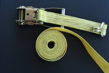 Top view of ratchet cargo strap and rolled tie-down