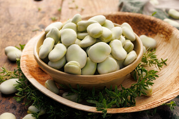 Fresh broad bean in a ceramic bowl, close up view