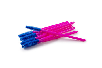Disposable eyelash brush wands arranged on a white isolated background, professional cosmetic tools used for lash extension, grooming and hygienic makeup application