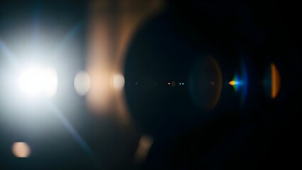 Bright lens flare overlay effect with light streaks and bokeh on a dark background, abstract photography