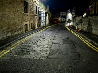 A quiet, night-time moment on a cobbled alleyway in Edinburgh, Scotland, United Kingdom