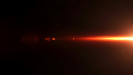 Bright orange lens flare overlay effect isolated on black background with light streaks