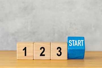 1, 2, 3 Start. Business concept. Starting a new project. Starting an advertising campaign. Written on wooden blocks 123 start. Copy space. Beautiful gray background. Close up