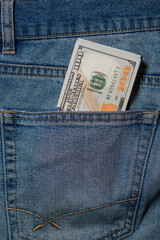 Money Tucked Into the Pocket of Blue Denim Jeans During a Casual Day