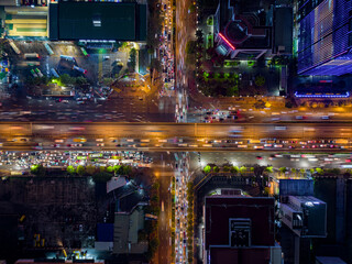 Aerial top-down view of busy city traffic at major intersection at night in Hanoi, Vietnam