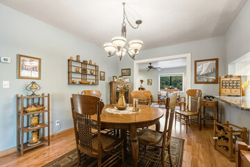 Tastefully Staged Dining Room Emphasizing Comfort And Elegance With Carefully Arranged Decor And Lighting