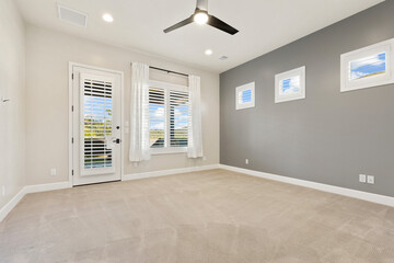 Peaceful Bedroom Featuring Sliding Barn Entry, Serene Sleeping Area With Neutral Carpeting And Natural Light