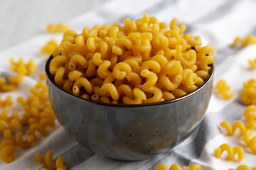 Dried Organic Amorosi Pasta in a Bowl, side view. Close-up.