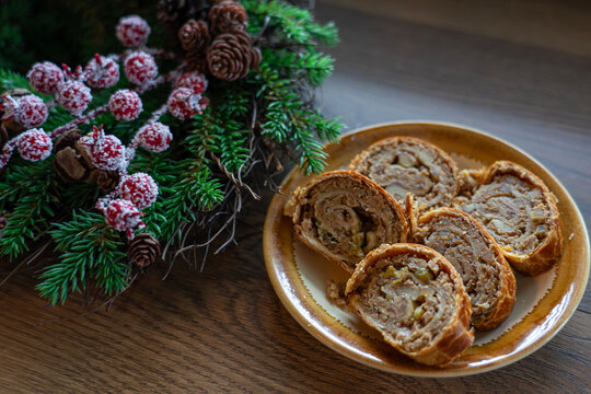 traditional hungarian christmas cookie called bejgli filled with walnut with christmas tree background