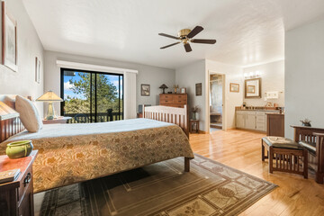 Sunny Bedroom With Balcony Access, Inviting Guest Suite With Scenic Views And Cozy Furnishings