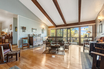 Large Room With Natural Light, Sunfilled Living Space Featuring Wooden Floors And Expansive Windows