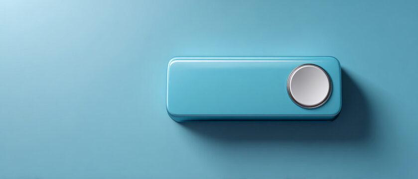 Minimalist blue rectangular device with a circular metallic button casting shadow on a smooth blue surface in soft lighting