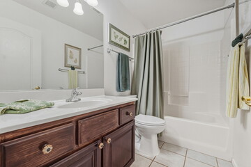 Chic Guest Washroom With Amenities, Calm And Inviting Bathroom With Tiled Surround And Soft Towels