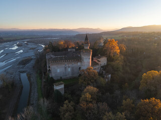 Aerial view of castle and surrounding countryside at sunset along the Trebbia River, Piacenza, Emilia-Romagna, Italy