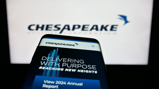 Stuttgart, Germany - 11-26-2025: Mobile phone with website of US company Chesapeake Utilities Corporation on screen in front of logo. Focus on top-left of phone display.