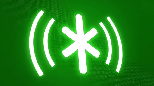 Animated glowing green asterisk symbol rotating and radiating waves.