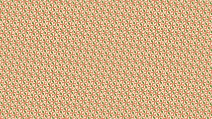 Obraz premium A patterned orange and green background with a green leaf