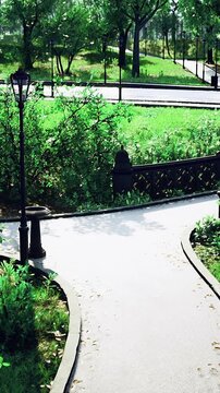 Sunlight filters through vibrant leaves as people stroll along winding paths in a peaceful park. The lush greenery and manicured gardens invite relaxation and exploration.