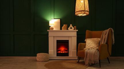 Fototapeta premium Interior of dark living room with fireplace, armchair and glowing lamps at night