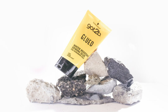 12.-1.2025, Zory, Poland, Got2b styling product placed on natural stones, editorial image showing branded hair styling glue in a creative composition highlighting strong hold and product identity