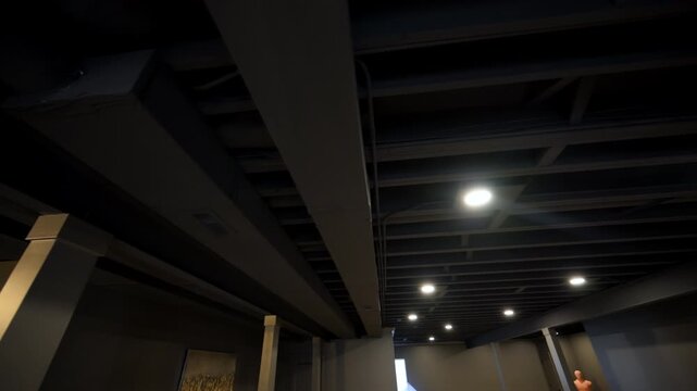 HVAC heating, air ventilation, air conditioning systems under ceiling in empty basement in residential house under renovation process