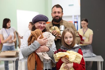 Homeless people with clothes and food in shelter