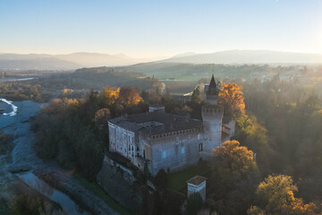 Aerial view of castle and surrounding countryside at sunset along the Trebbia River, Piacenza, Emilia-Romagna, Italy