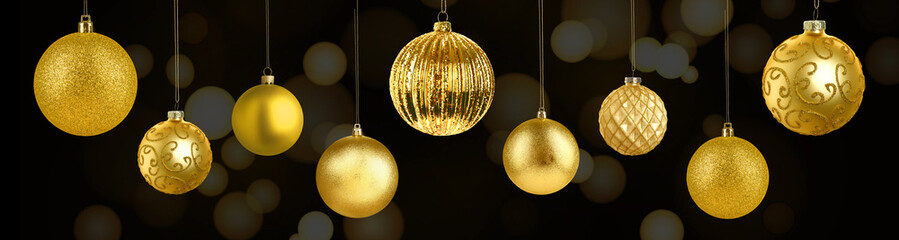 Christmas balls against black background with magic lights. Golden festive ornaments, banner design