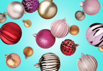 Christmas balls flying in air on light blue background