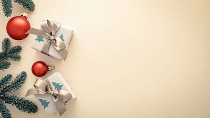 Christmas Gifts, Red Baubles and Fir Branches on Beige Background