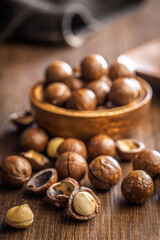 Tasty macadamia nuts on wooden table.