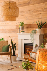 Fototapeta premium Stylish fireplace and armchairs near wooden wall